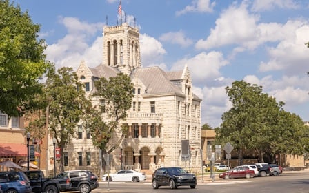 A street with cars and buildings on the side.