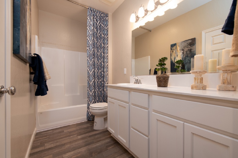 A bathroom with a large mirror.