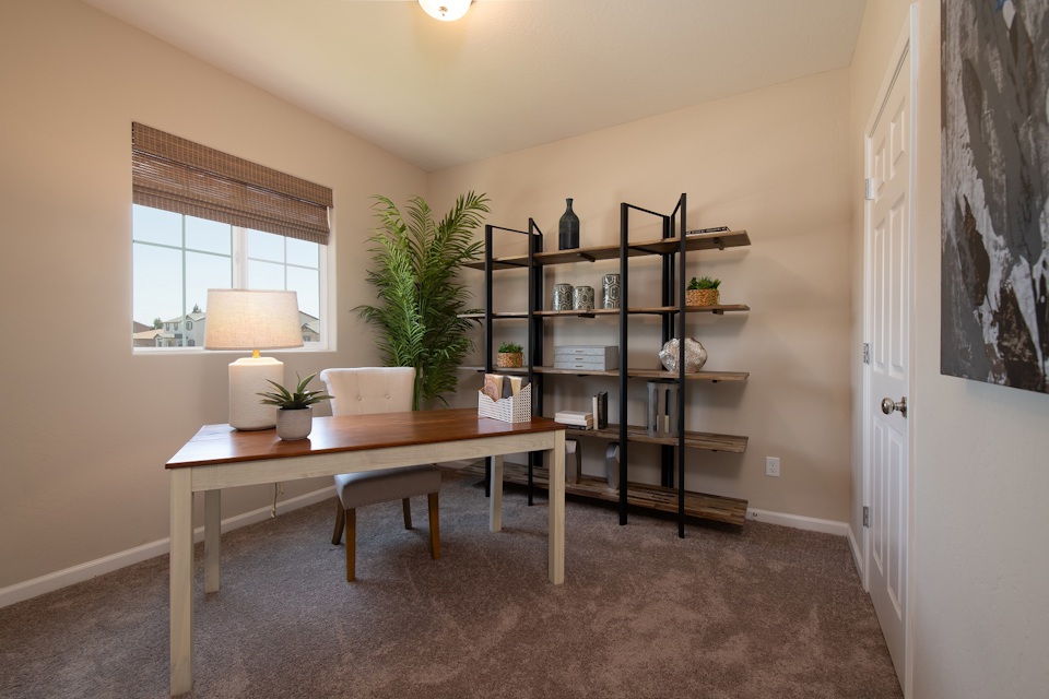 A room with a table and shelves.