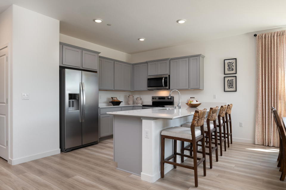 A kitchen with white cabinets.
