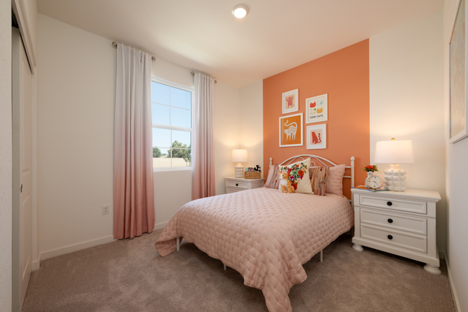 A bedroom with a bed and a window.