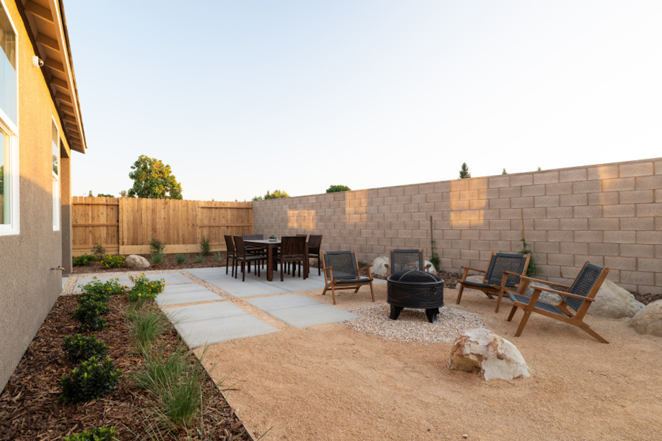 A patio with chairs and tables.