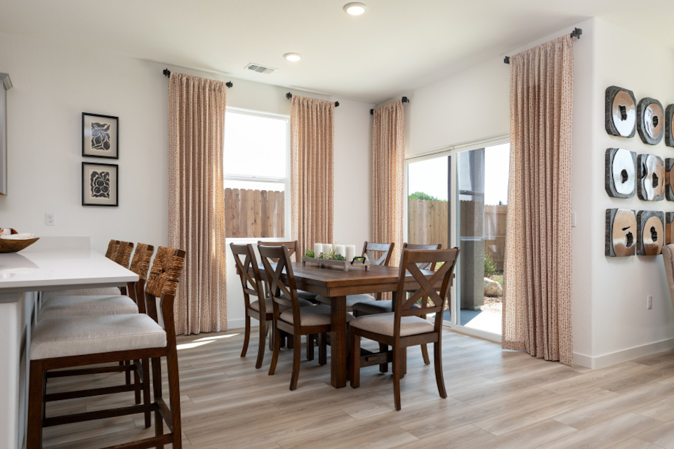 A dining room with a wood floor.