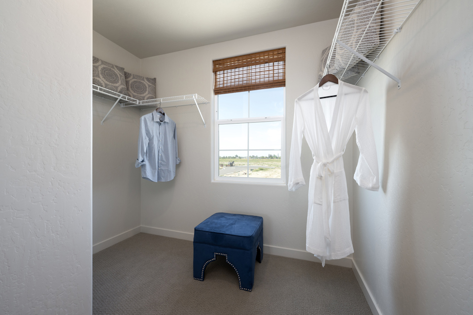 A room with clothes on the wall.