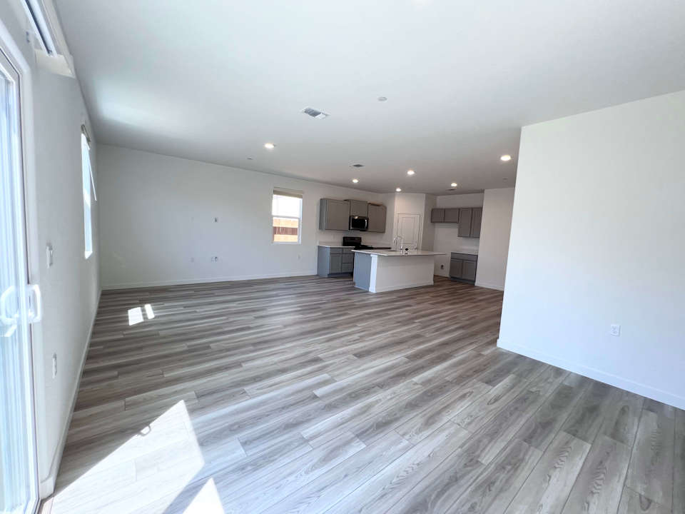 A room with a wood floor and white walls.