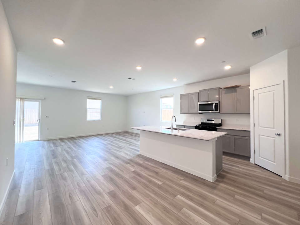 A kitchen with white cabinets.