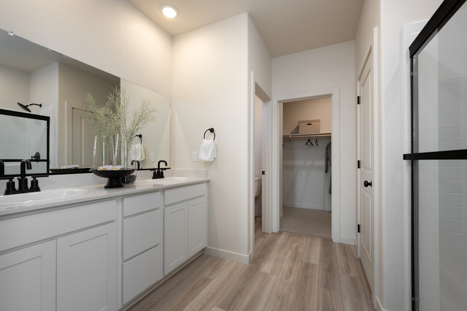 A bathroom with white cabinets.