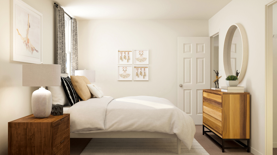 A bedroom with a bed and a mirror.