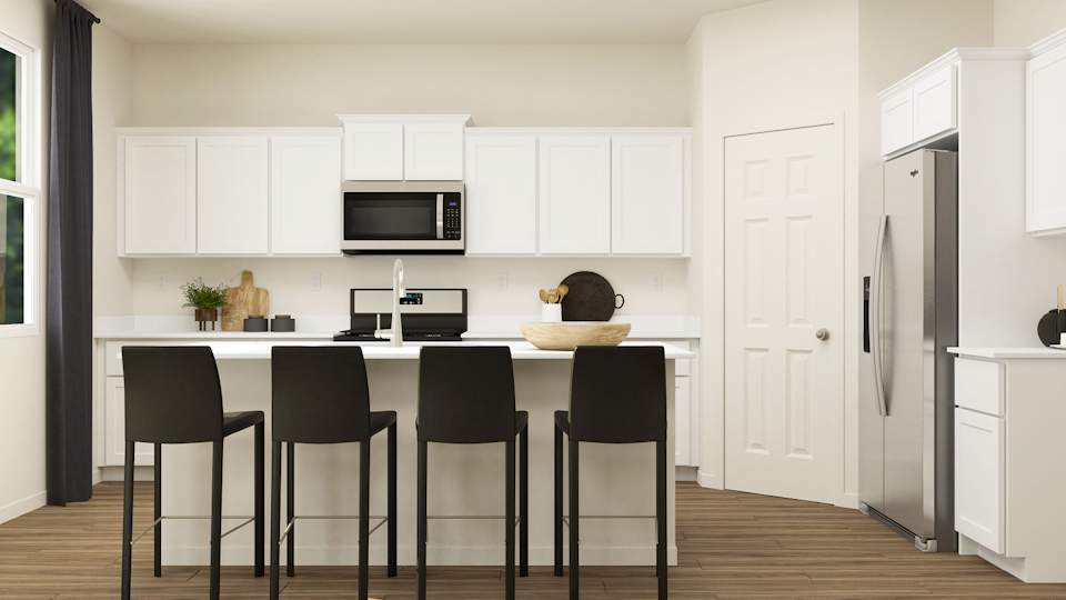 A kitchen with white cabinets.
