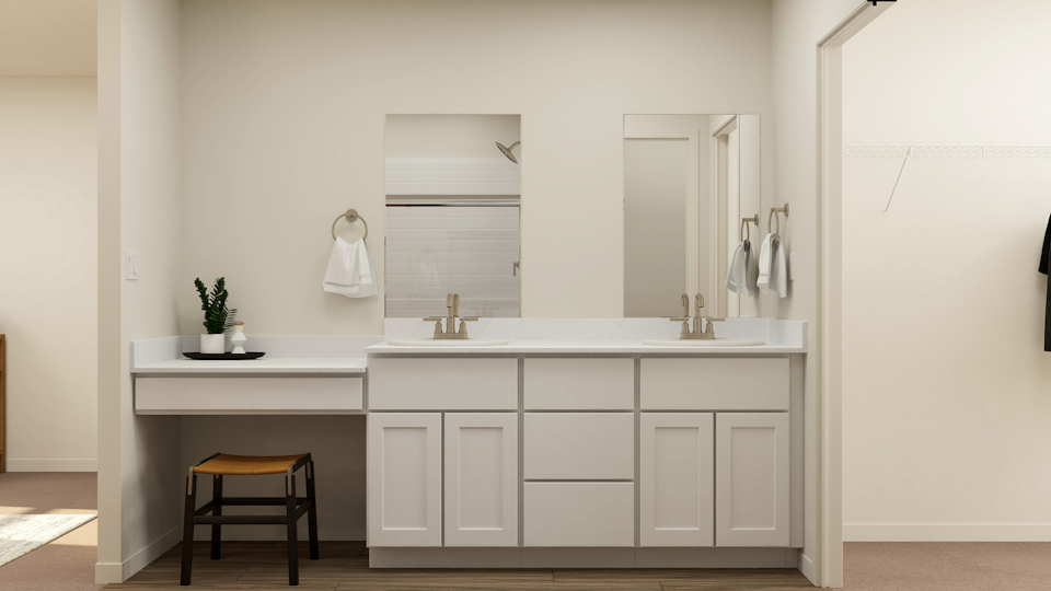 A white kitchen with a white countertop and a stool.