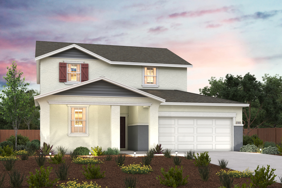 A house with a garage and bushes.