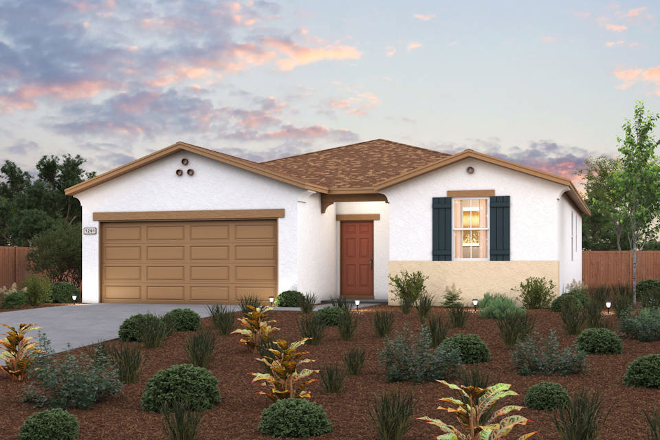 A house with a garage and bushes in front of it.