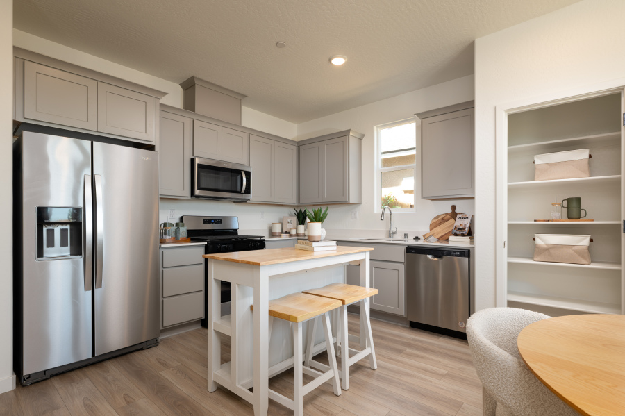 A kitchen with white cabinets.