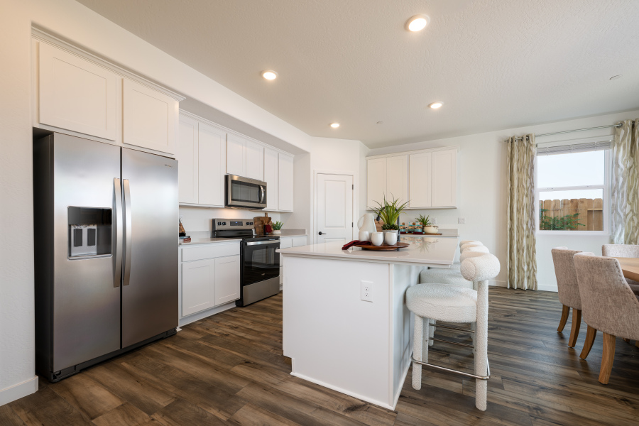 A kitchen with white cabinets.