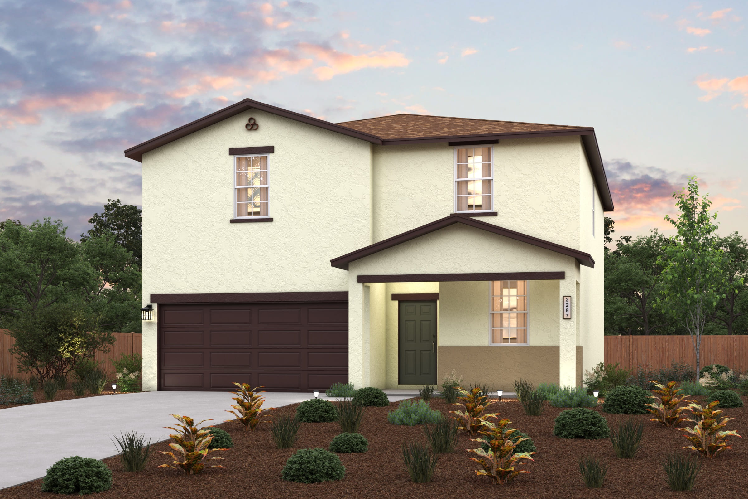 A house with a garage and bushes in front of it.