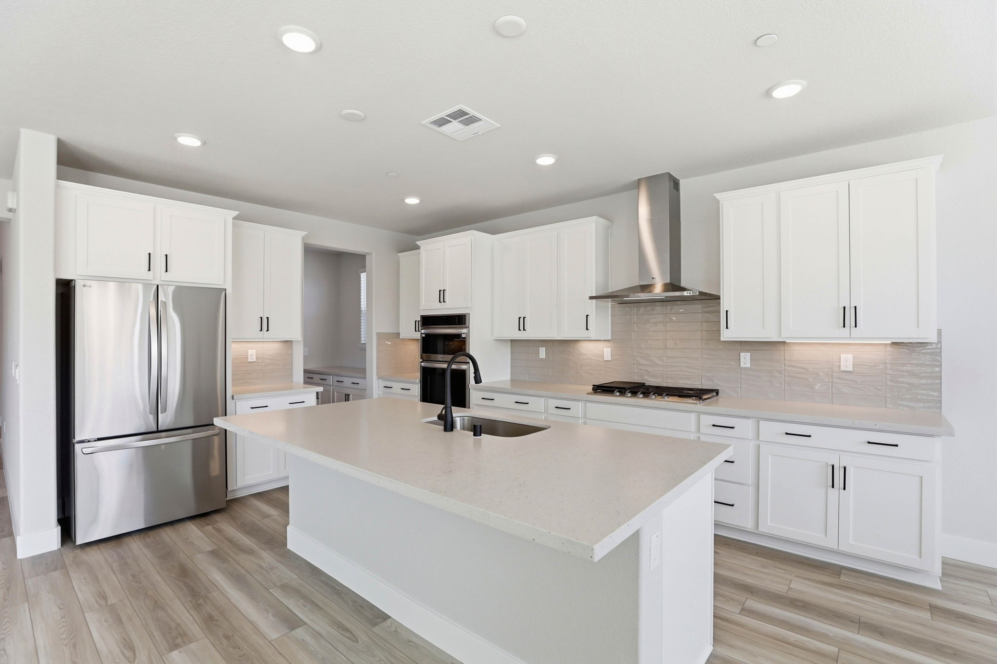 A kitchen with white cabinets.