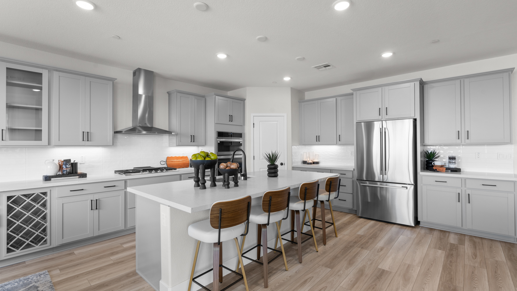 A kitchen with white cabinets.