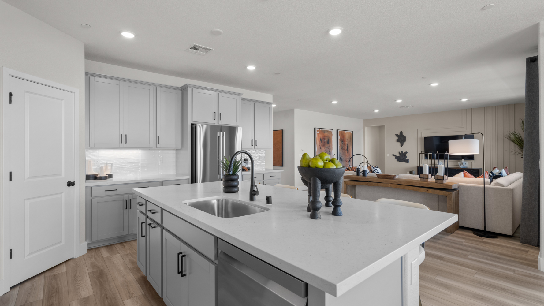 A kitchen with white cabinets.