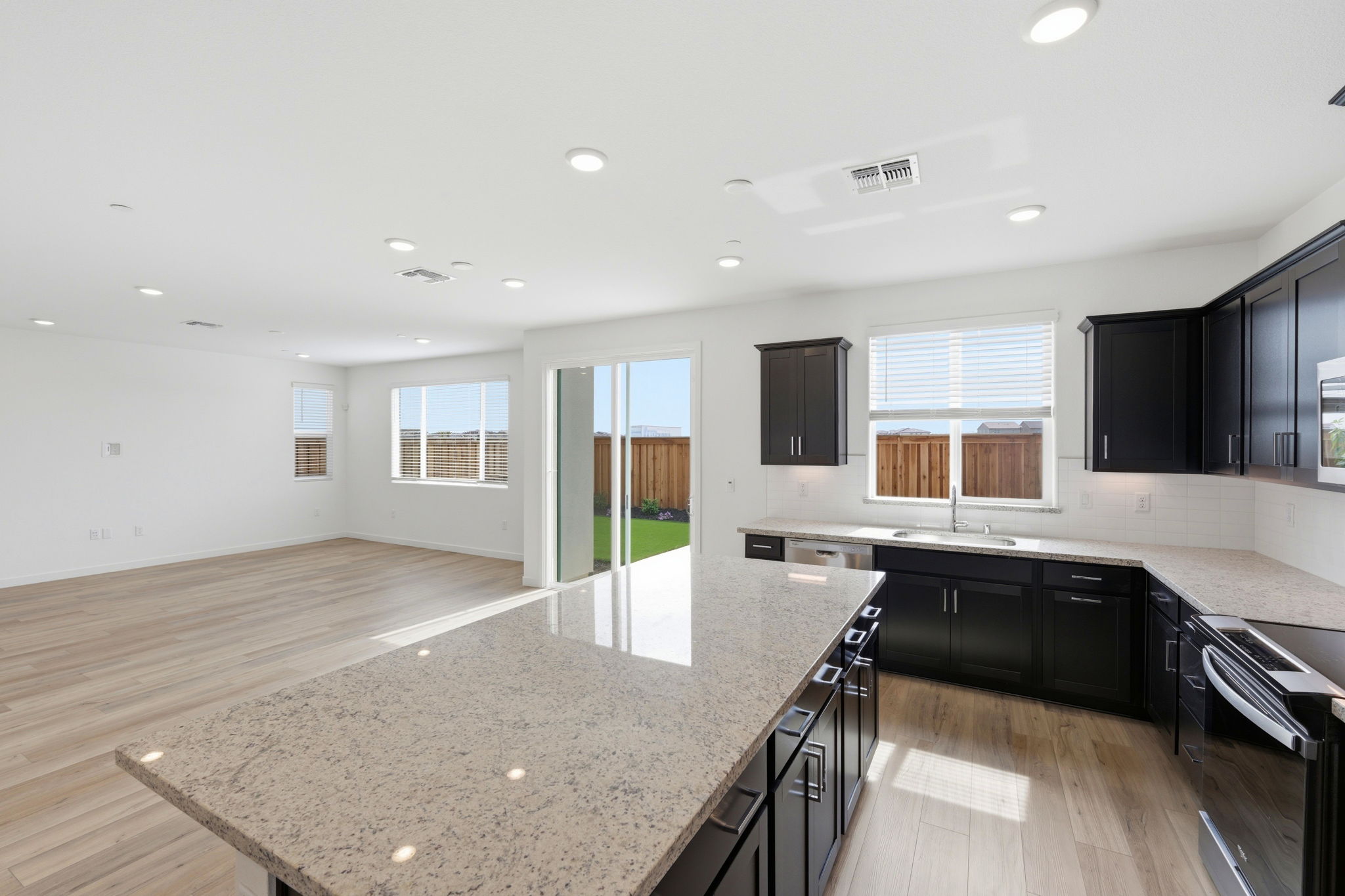 A kitchen with black cabinets.