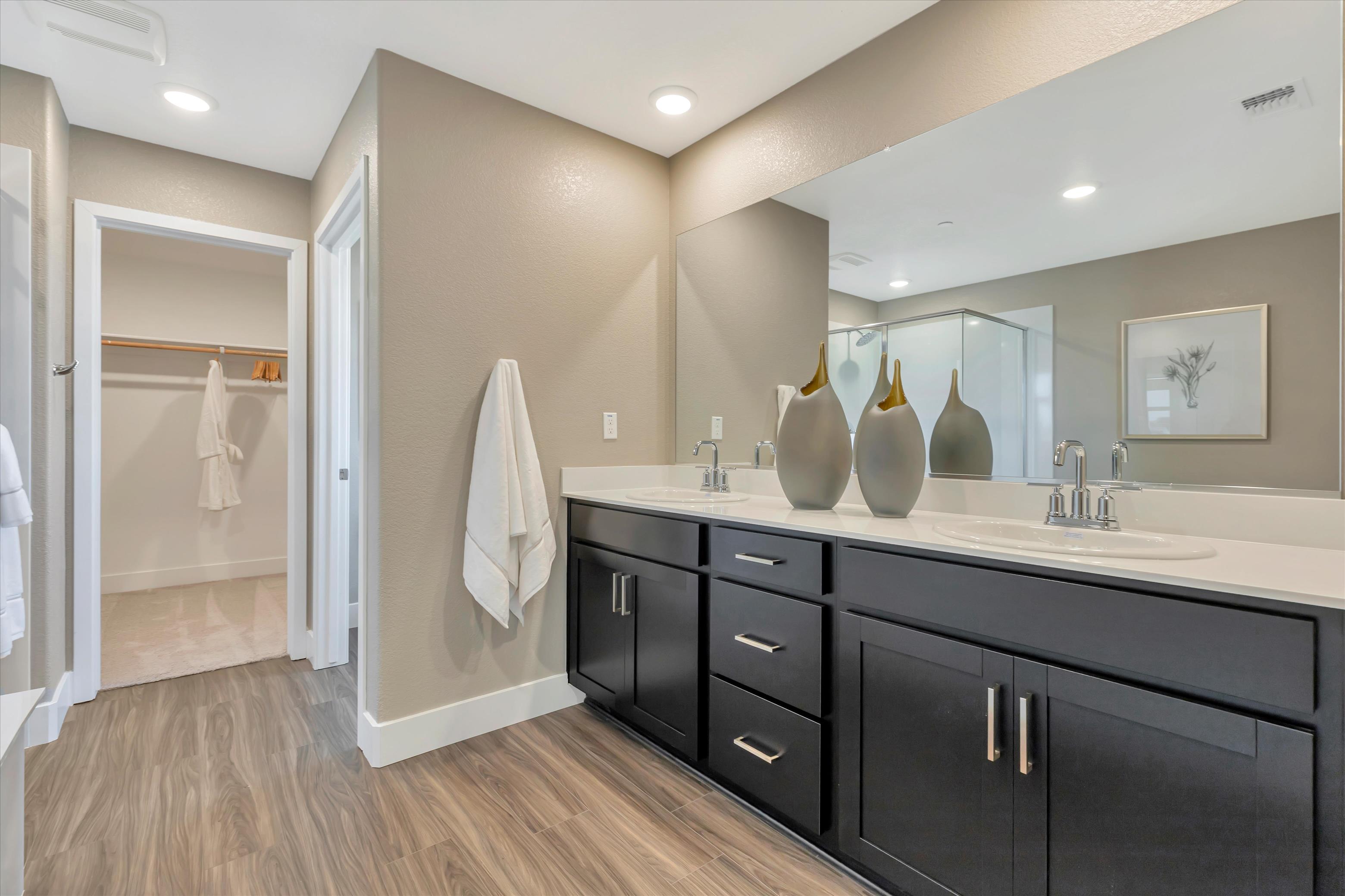A bathroom with a large mirror.