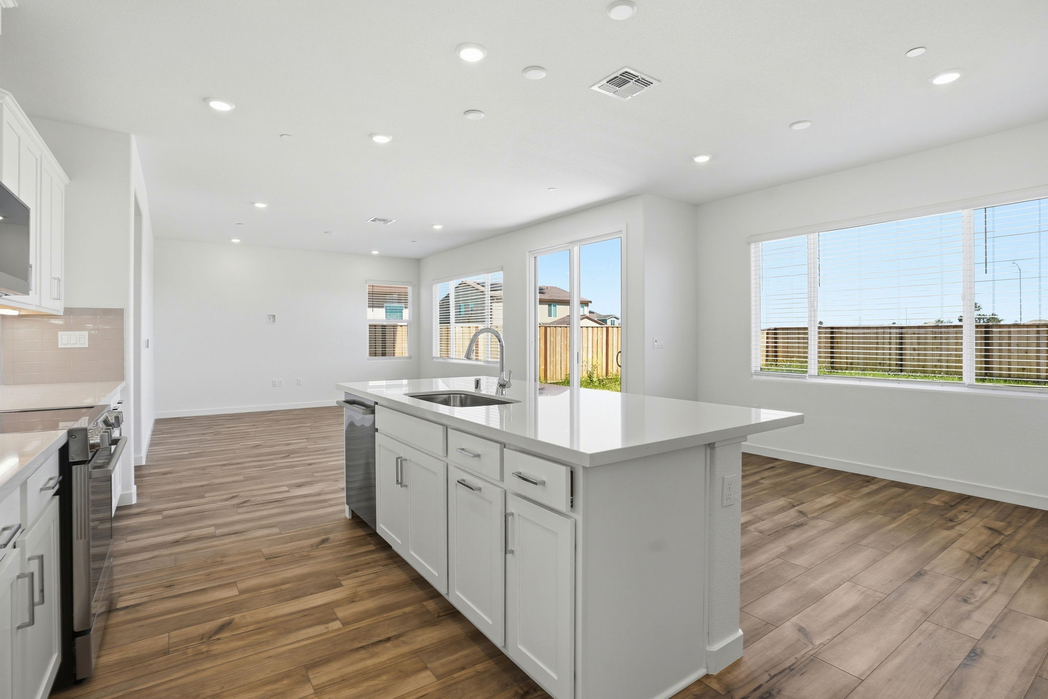 A kitchen with white cabinets.