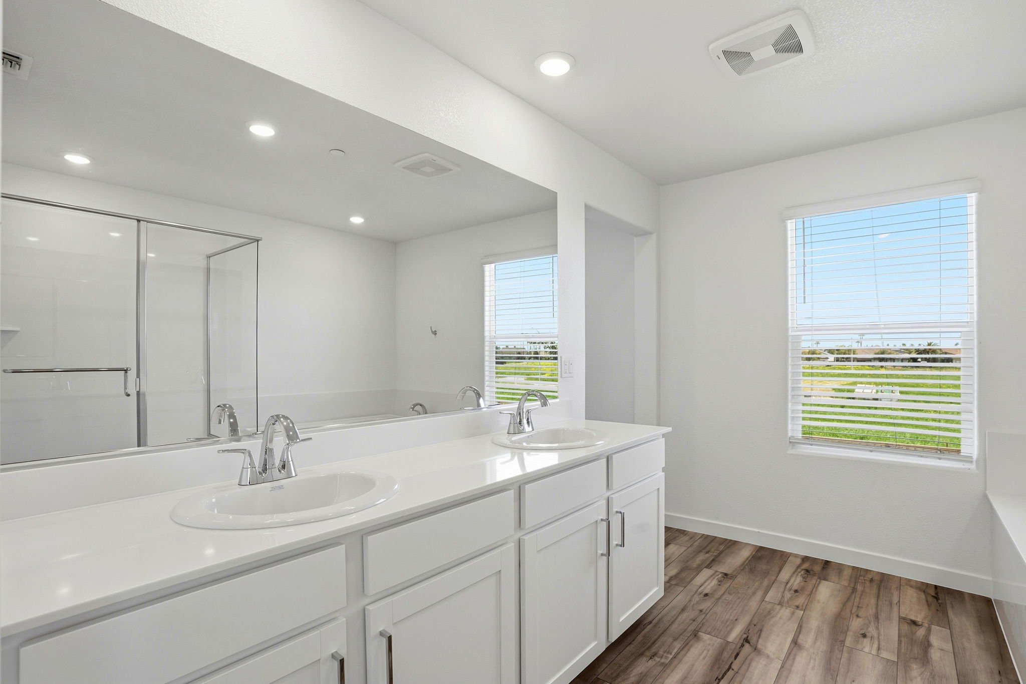 A bathroom with a large mirror.