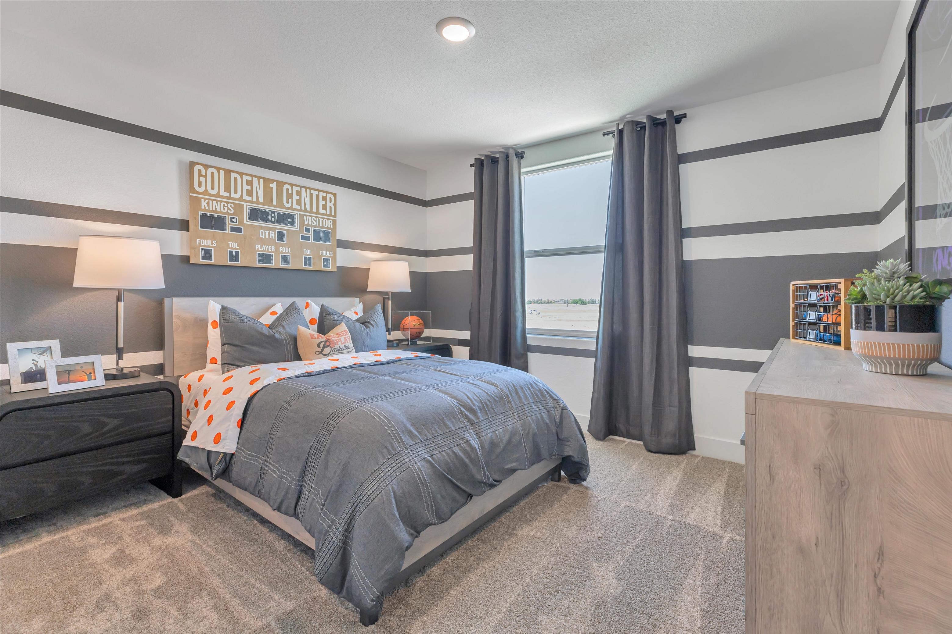 A bedroom with a large window.