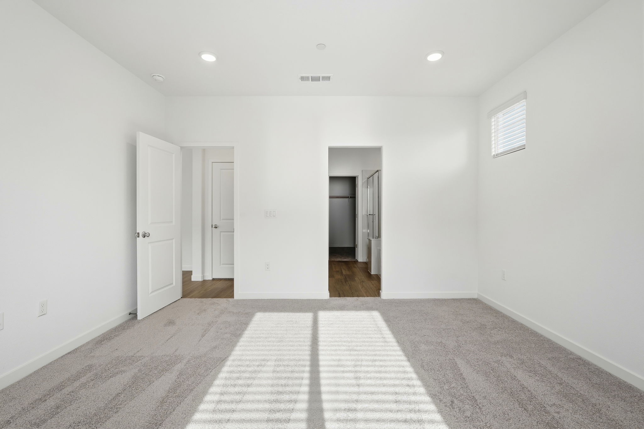 A hallway with white doors.