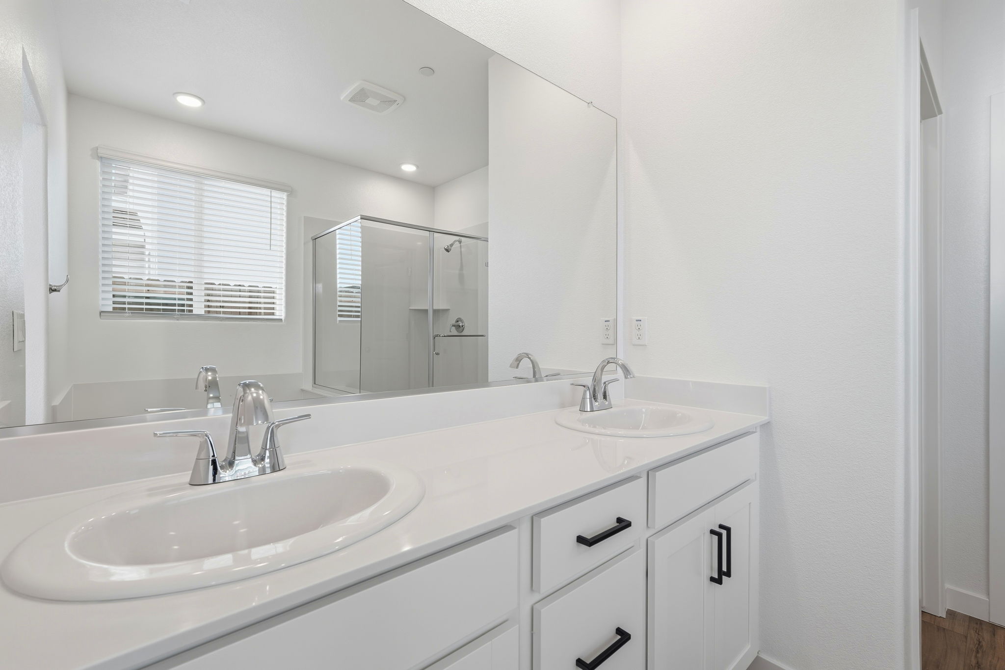 A bathroom with a large mirror.