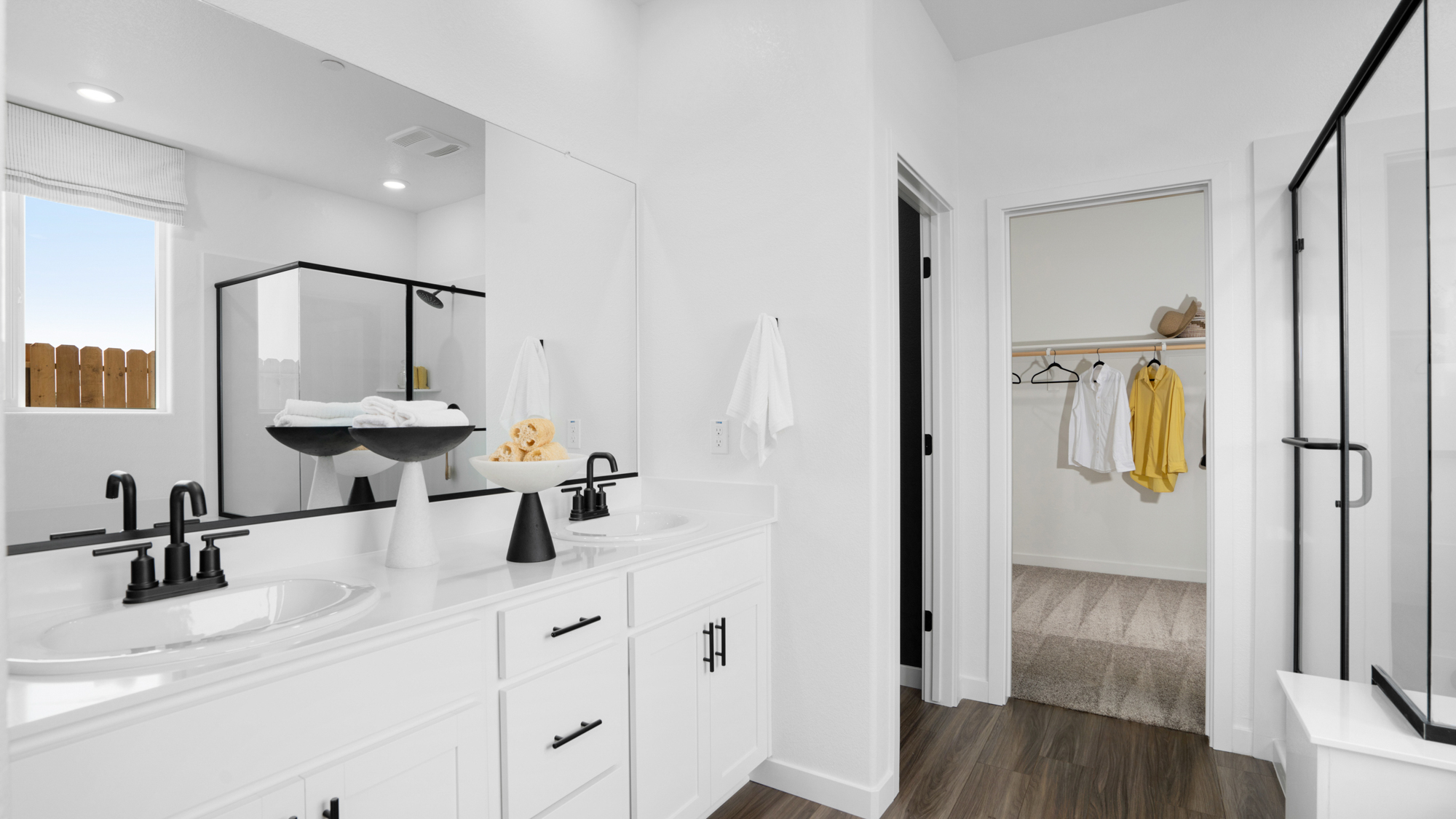 A bathroom with white cabinets.