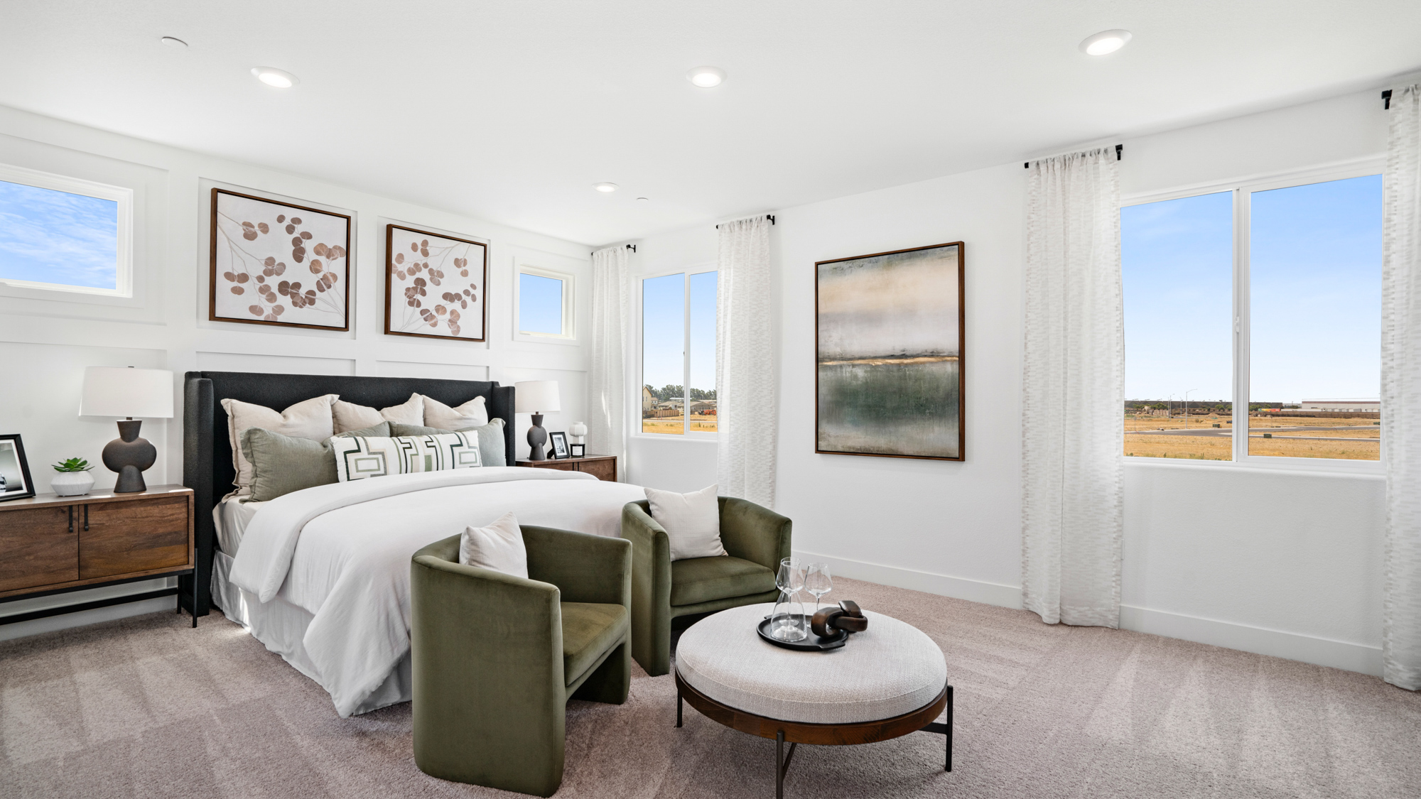 A room with a couch and a table with a lamp and a window.