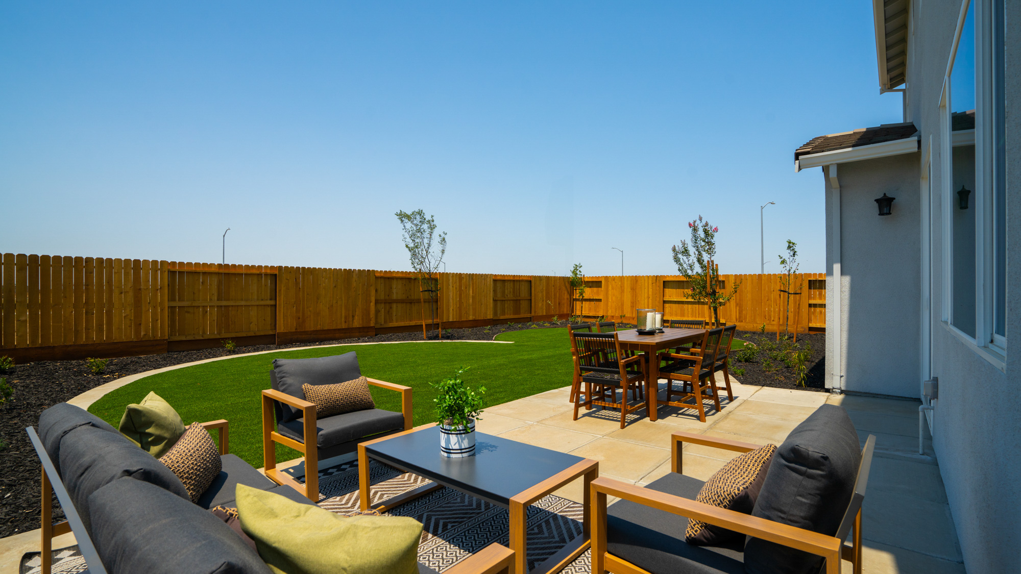 A patio with a table and chairs.