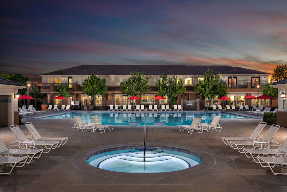 A pool with chairs around it.