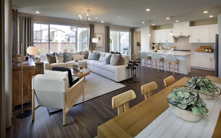 A living room with a large kitchen.