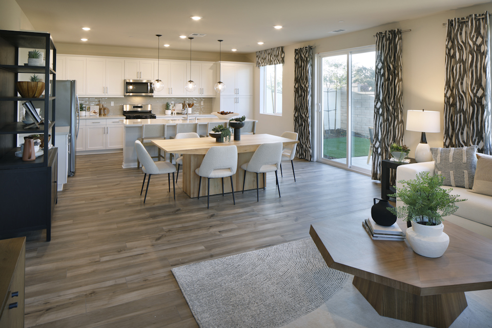 A large kitchen with a dining table.