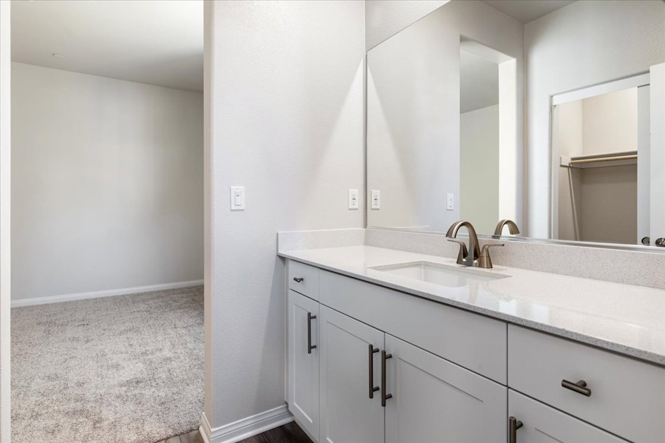 A bathroom with a large mirror.