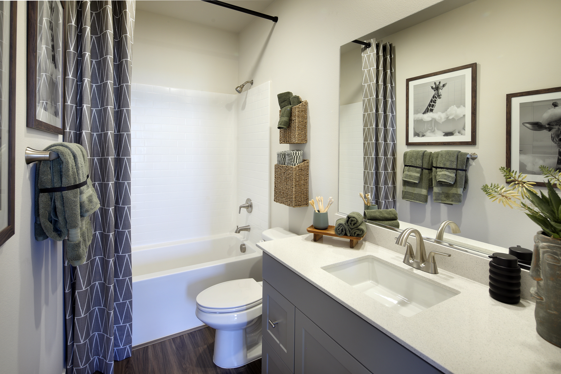 A bathroom with a sink toilet and a bathtub.