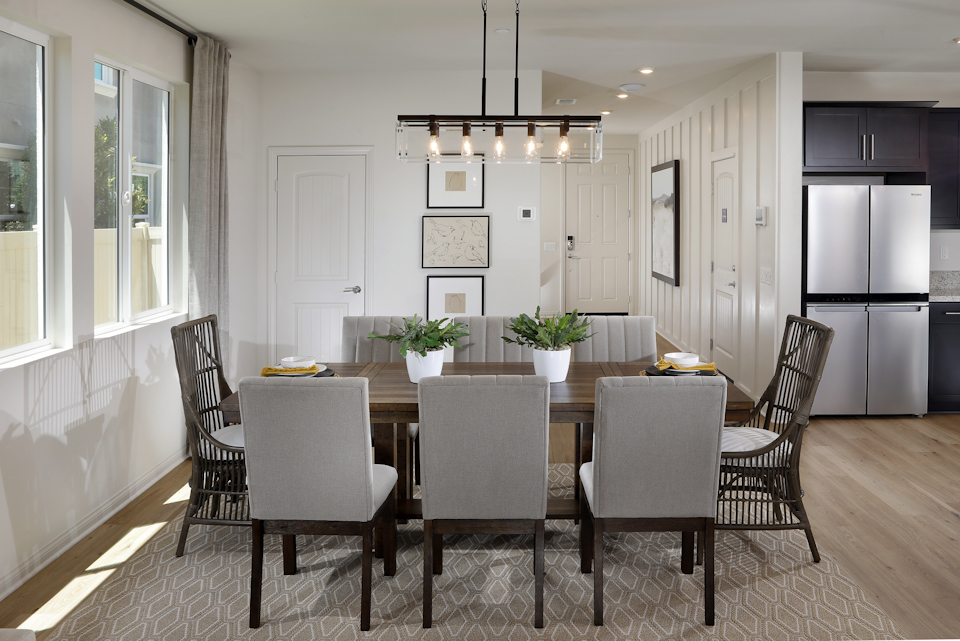A dining room with a table and chairs.