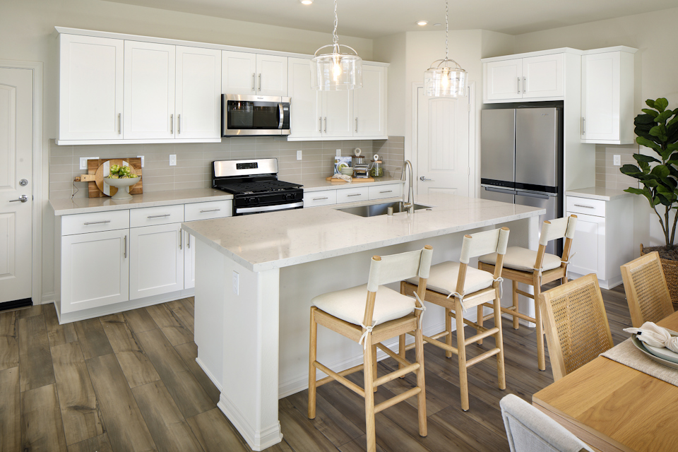 A kitchen with white cabinets.