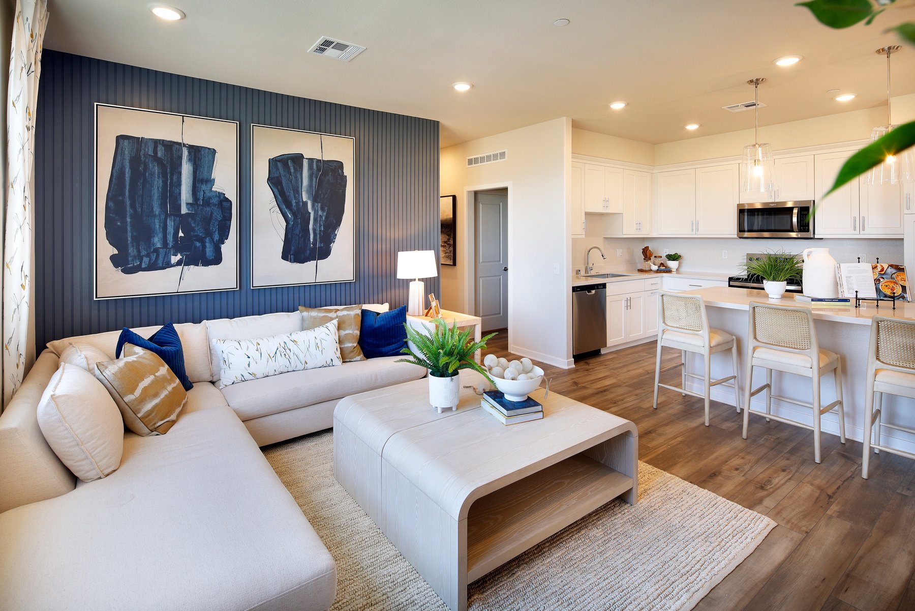 A living room with a large kitchen.