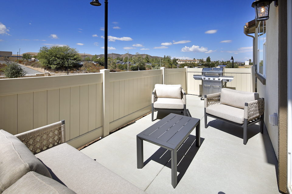A deck with chairs and a table.