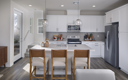 A kitchen with white cabinets.
