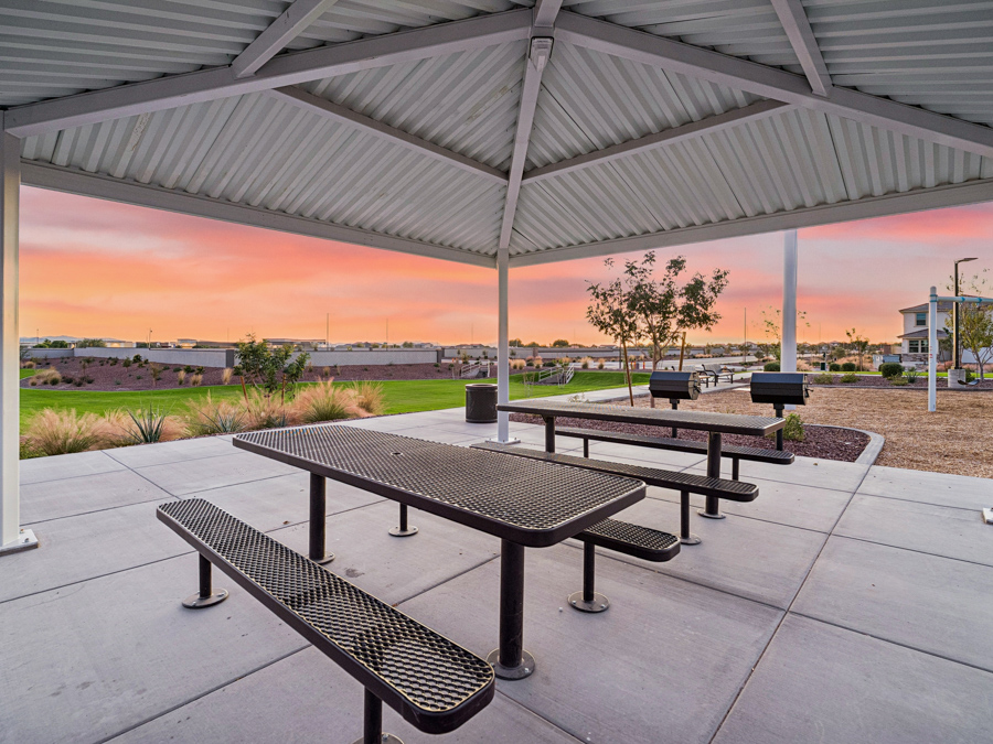 A group of picnic tables under a covered area.