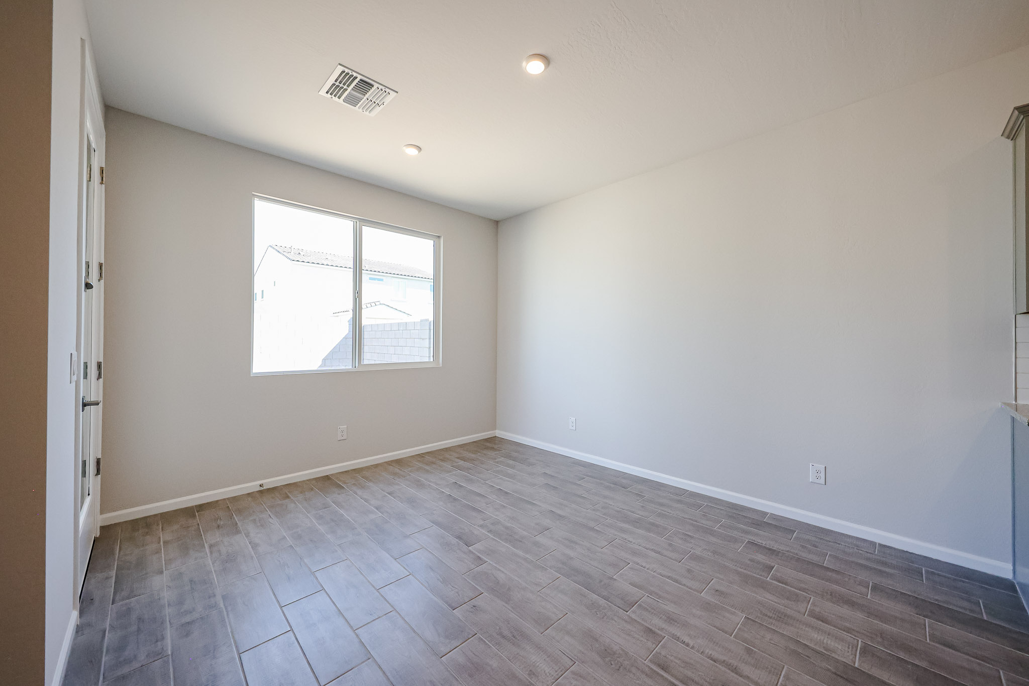 A room with a tile floor and a window.