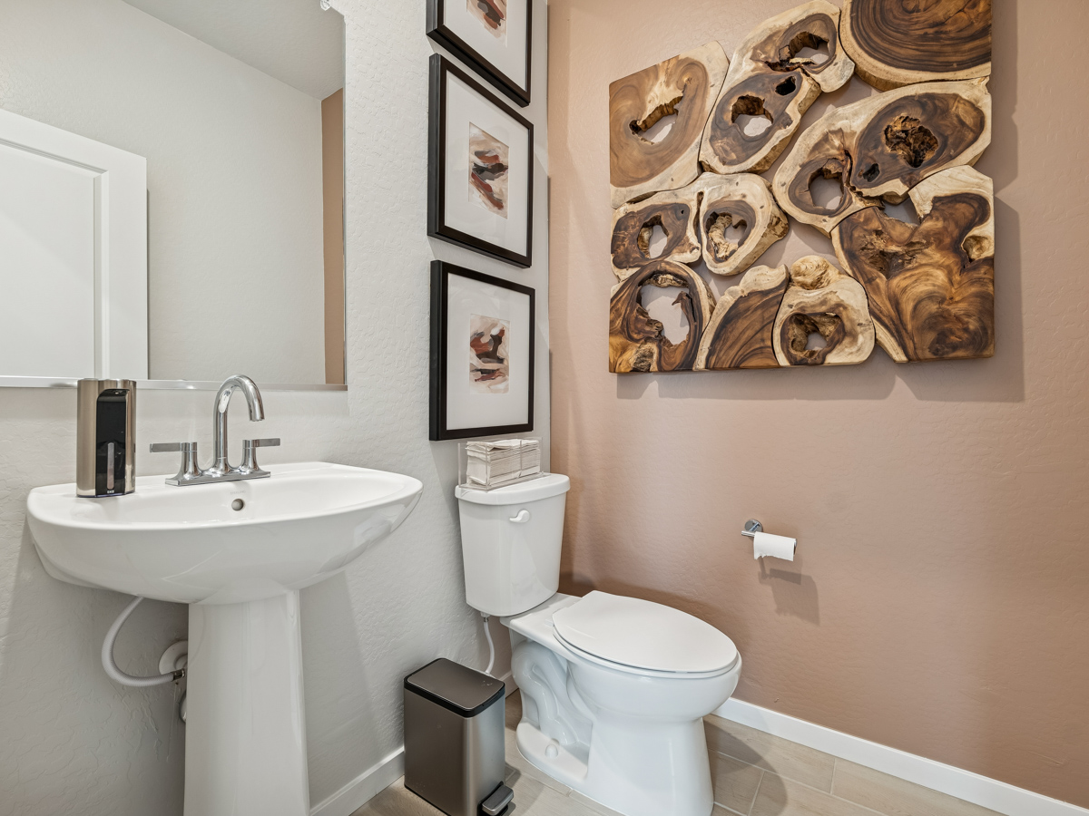 A bathroom with a toilet and sink.