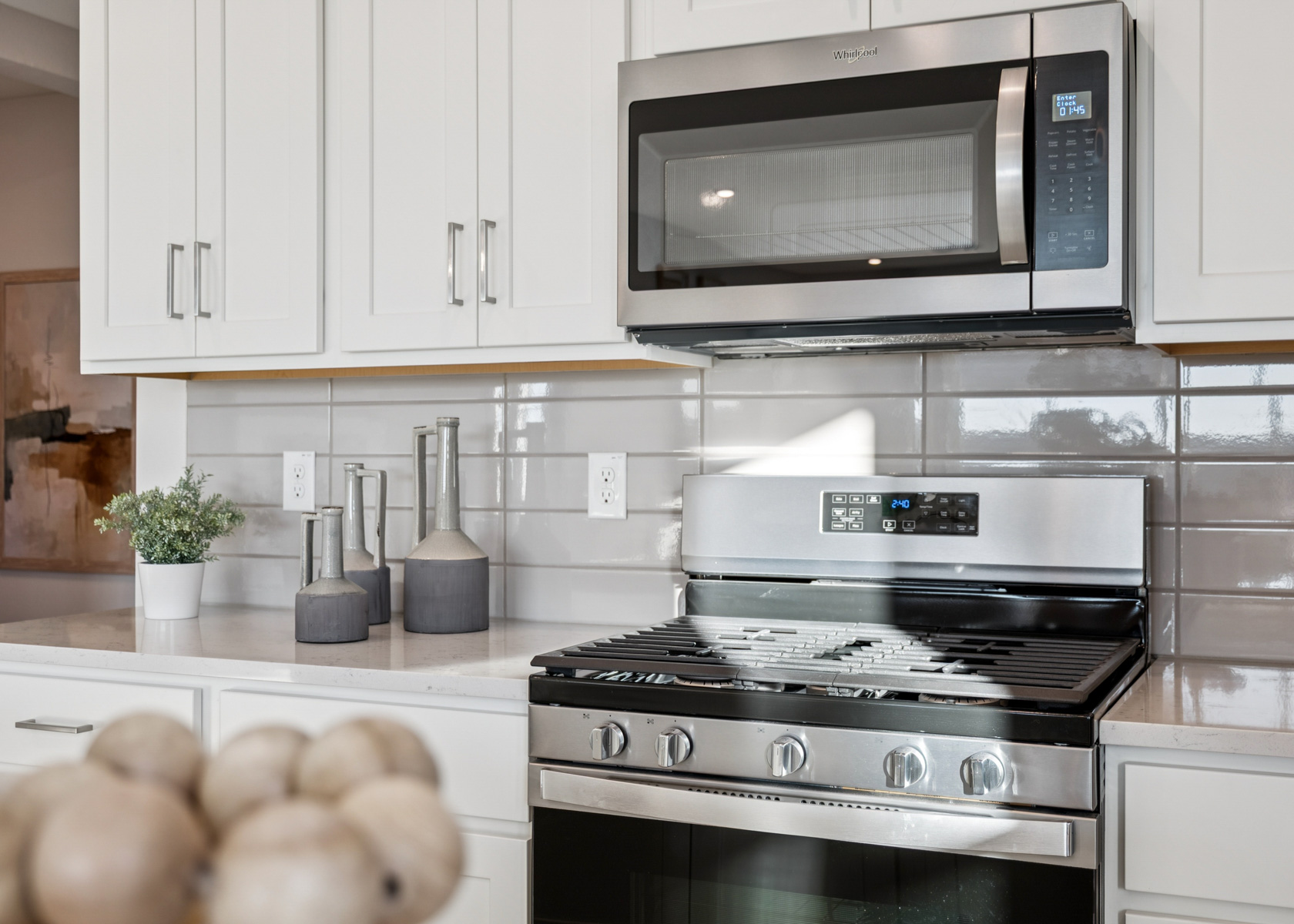 A kitchen with white cabinets.