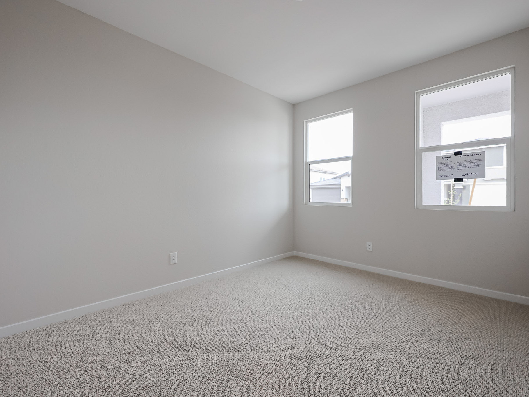 A room with a carpet and a window.