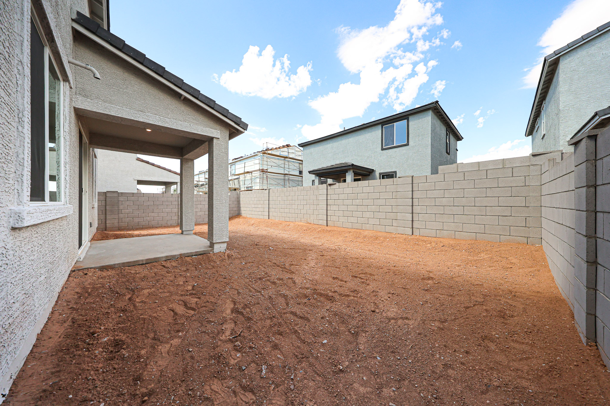 A dirt path between two buildings.