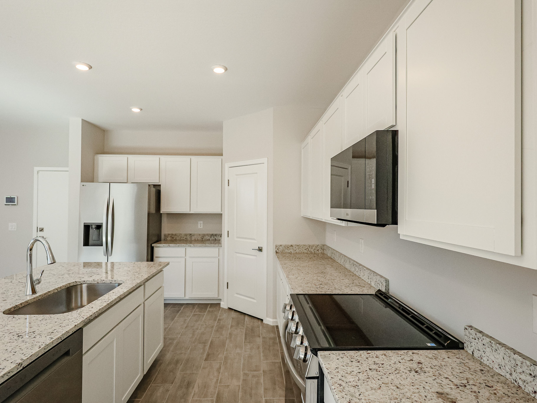 A kitchen with white cabinets.