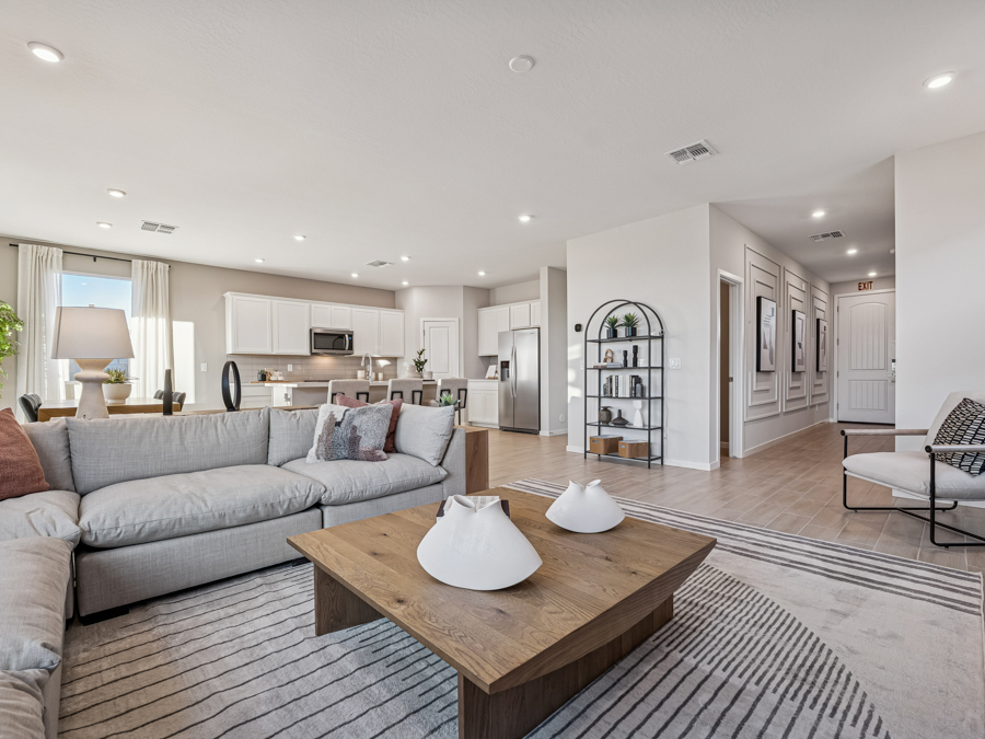 A large living room with a large wood floor and a large glass wall.